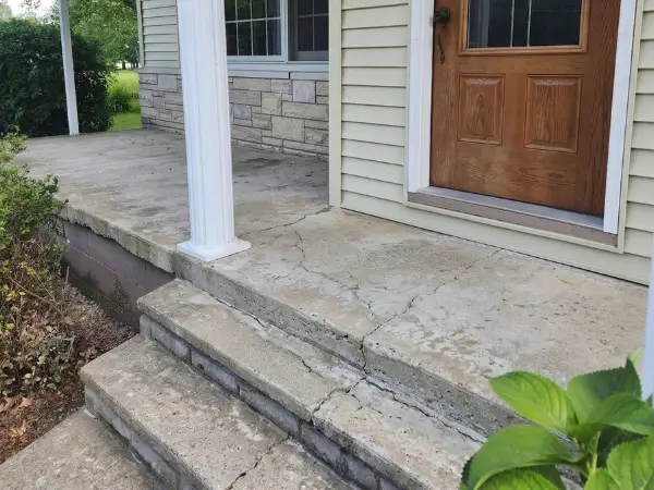 Faded backyard patio with worn concrete before refinishing